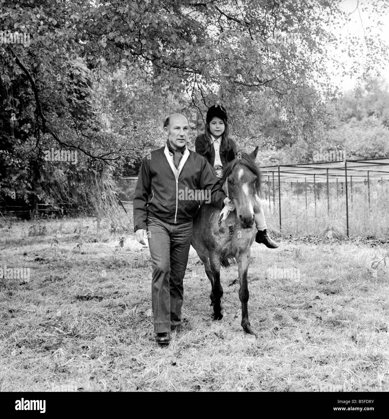 Sterling Moss (Ex Racing Driver). Seen here with horse and daughter. June 1974 S74-3861-002 Stock Photo