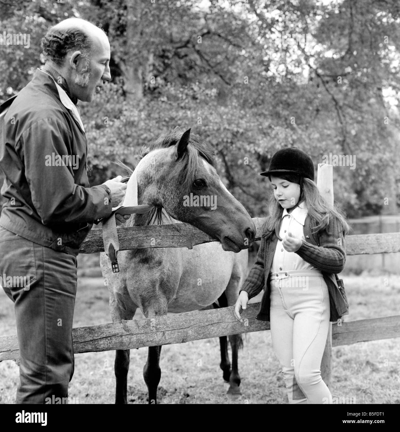 Sterling Moss (Ex Racing Driver). Seen here with horse and daughter. June 1974 S74-3861-003 Stock Photo