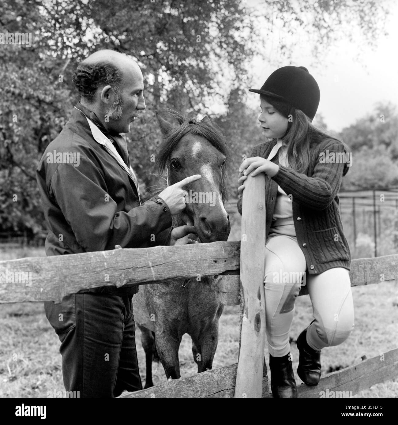 Sterling Moss (Ex Racing Driver). Seen here with horse and daughter. June 1974 S74-3861 Stock Photo