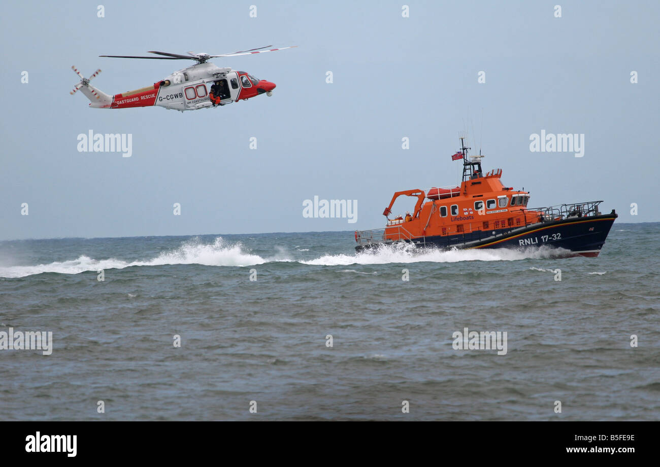 coast guard helicopter hovering over life boat Stock Photo