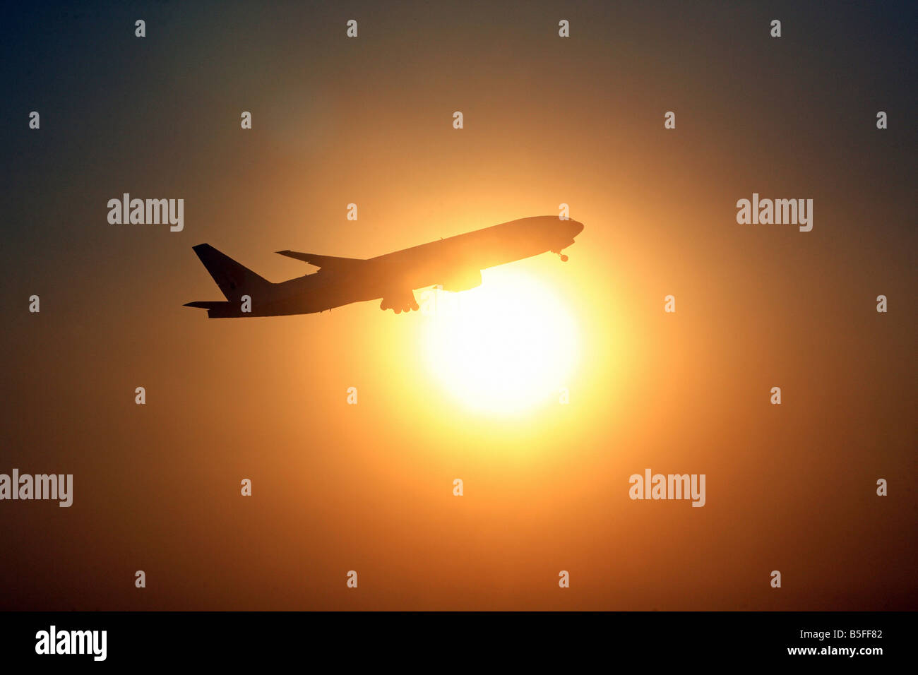 Passenger plane shortly after take-off in front of the sun Stock Photo ...