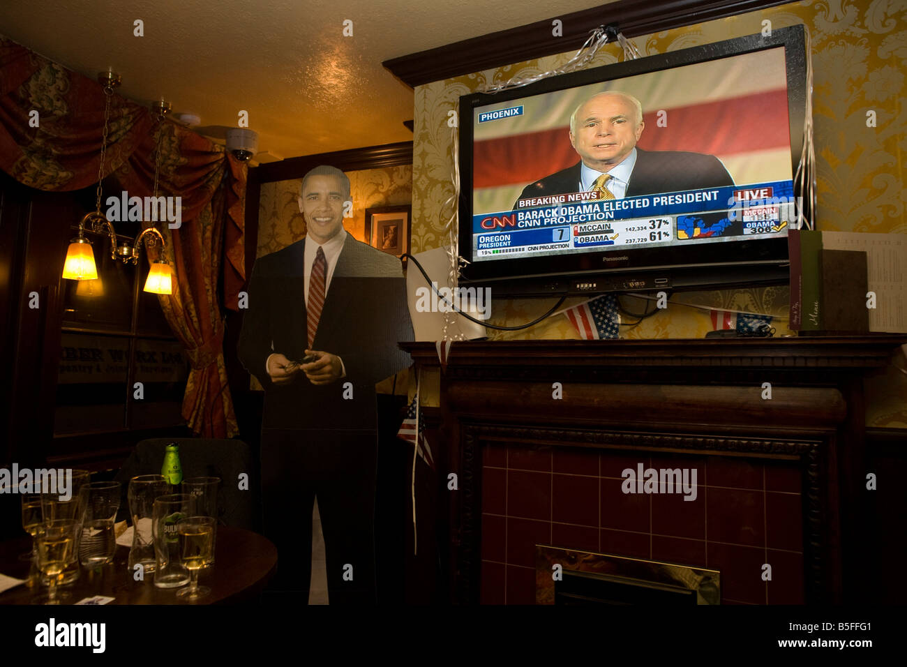 Senator John McCain concedes defeat by life-sized cut-out of Barack Obama after overnight 2008 election party in London Stock Photo