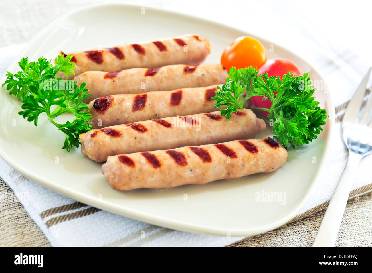 Serving of grilled breakfast sausages on a plate Stock Photo Alamy