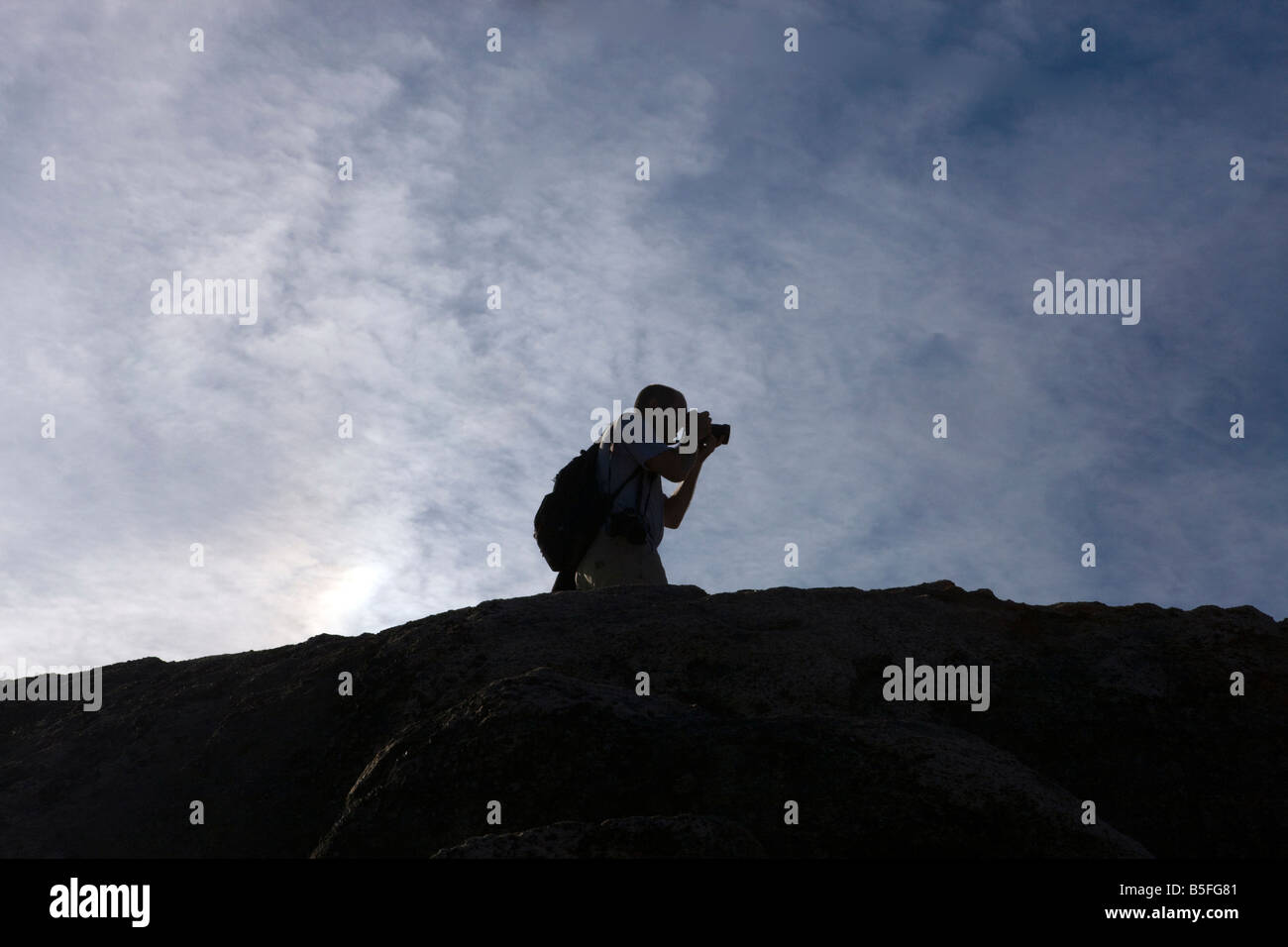 Silohuette of a male photographer against a deep blue sky, Old Rag Mountain, Shenandoah National Park, Virginia. Stock Photo