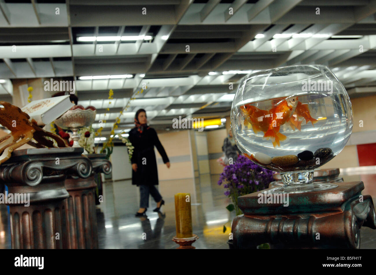 A goldfish in a bowl figures as part of a NoRuz  display at Mehrabad Airport celebrating Iranian New Year Stock Photo