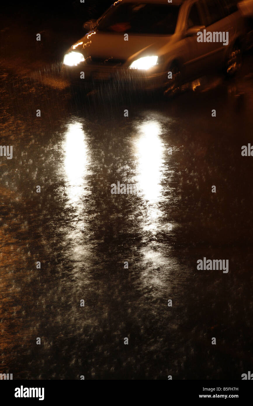 fast car driving in heavy rain at night in town Stock Photo - Alamy