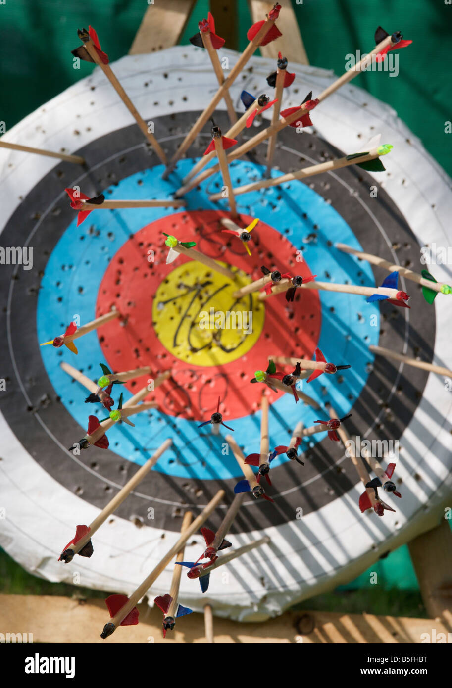 Closeup of several tens of arrows sticking in an archery target with