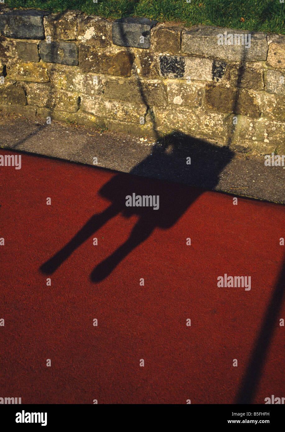 shadow of child swinging Stock Photo