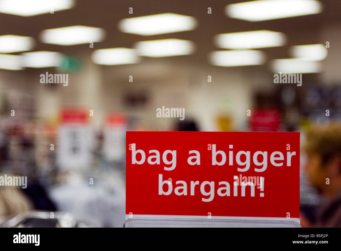 Recession hit Britain shoppers attracted to the Bargain Counters in a retail shop Sutton Surrey Stock Photo