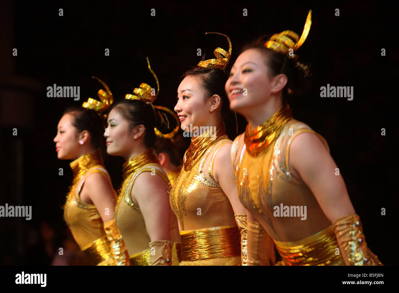 Chinese circus artists in golden costumes, Hong Kong, China Stock Photo