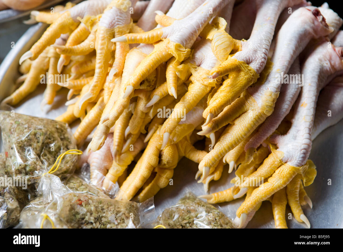 Chickens feet for sale in market in Vinh Long VIetnam Stock Photo
