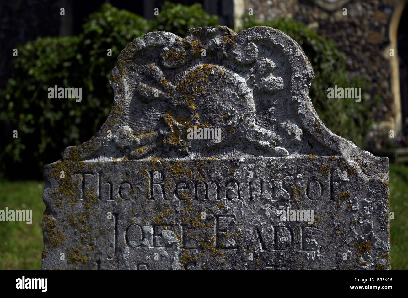 An old gravestone with a skull and crossbones motif in Saxmundham Stock