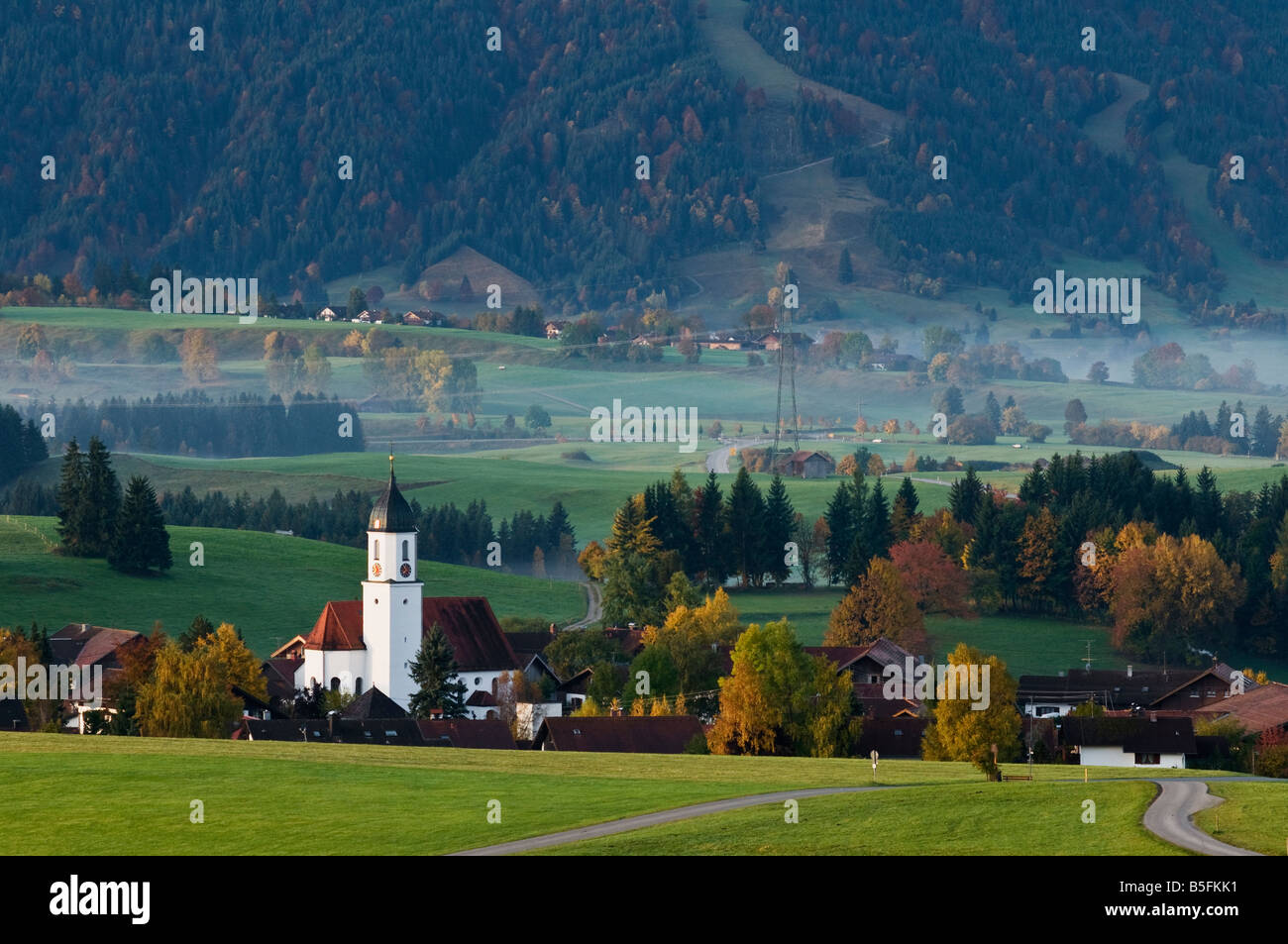 Church tower rises above village of Zell during autumn Allgäu region Bavaria Germany Stock Photo