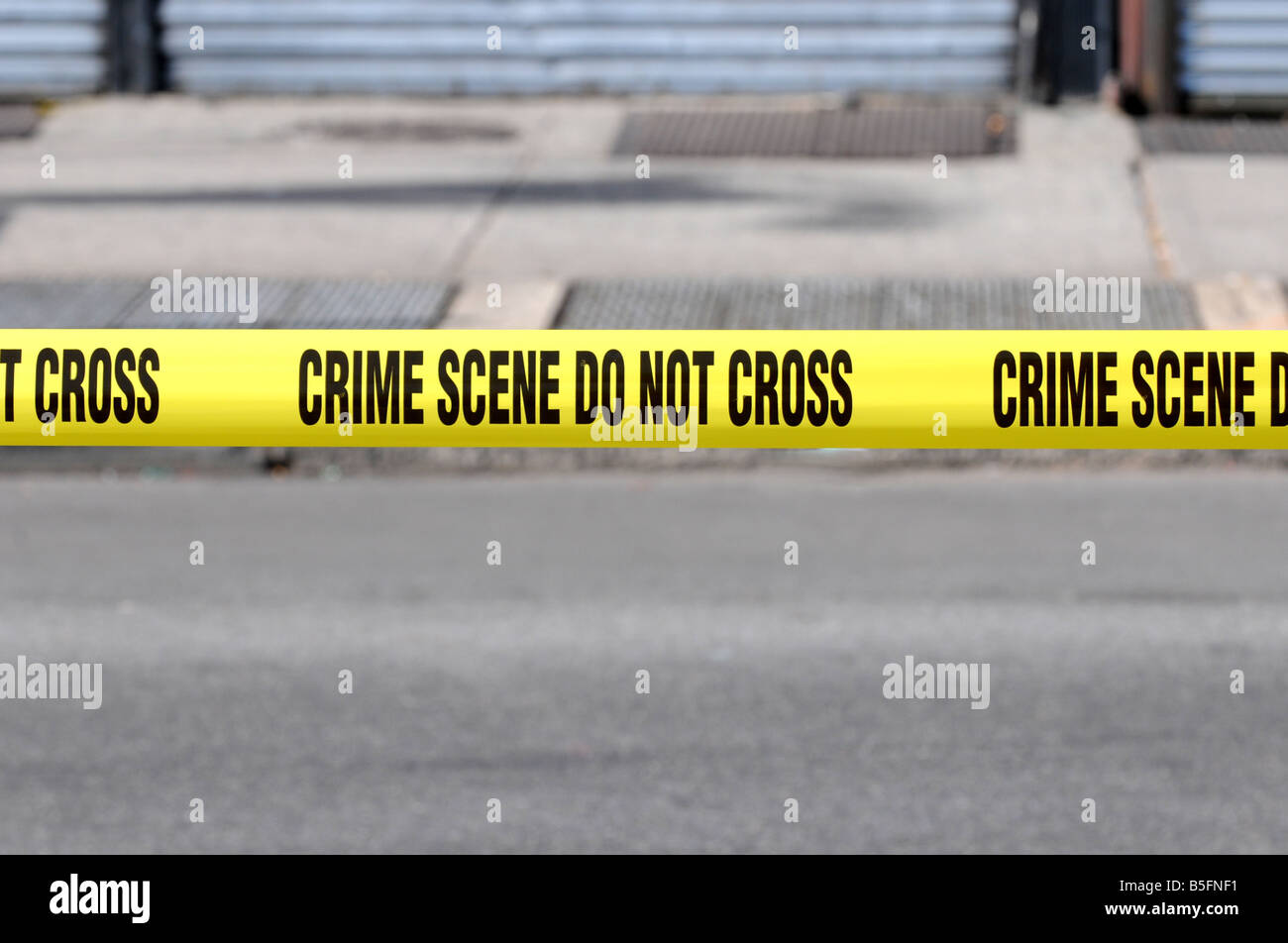 yellow tape closing street traffic designating a crime scene Stock Photo Alamy