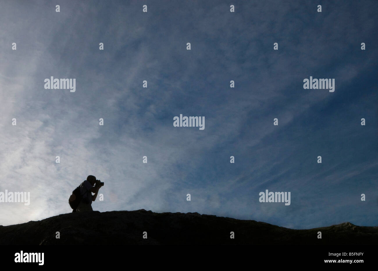 Silohuette of a male photographer against a deep blue sky, Old Rag Mountain, Shenandoah National Park, Virginia. Stock Photo