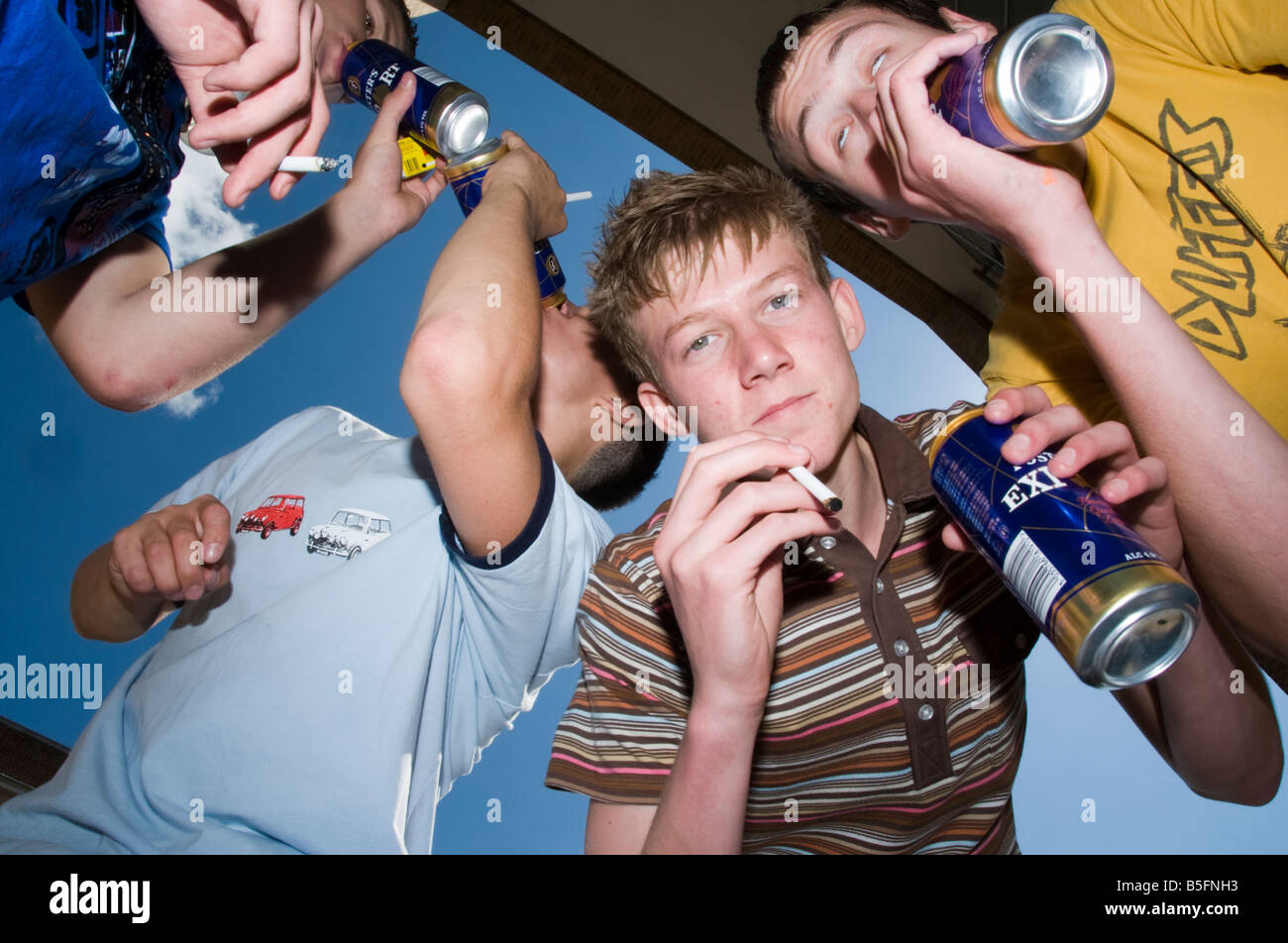group of teenage boys drinking and smoking Stock Photo