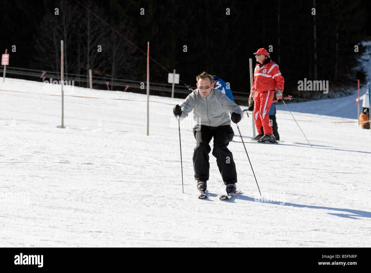 Beginner skier pushing down the nursery piste Stock Photo