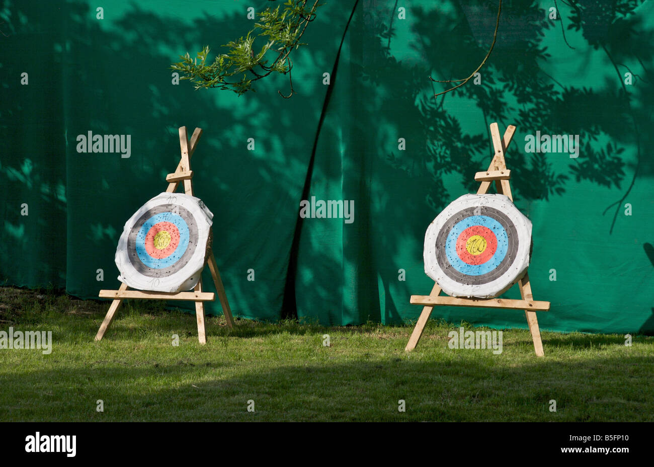 Two empty archery targets with colored rings and score numbers on