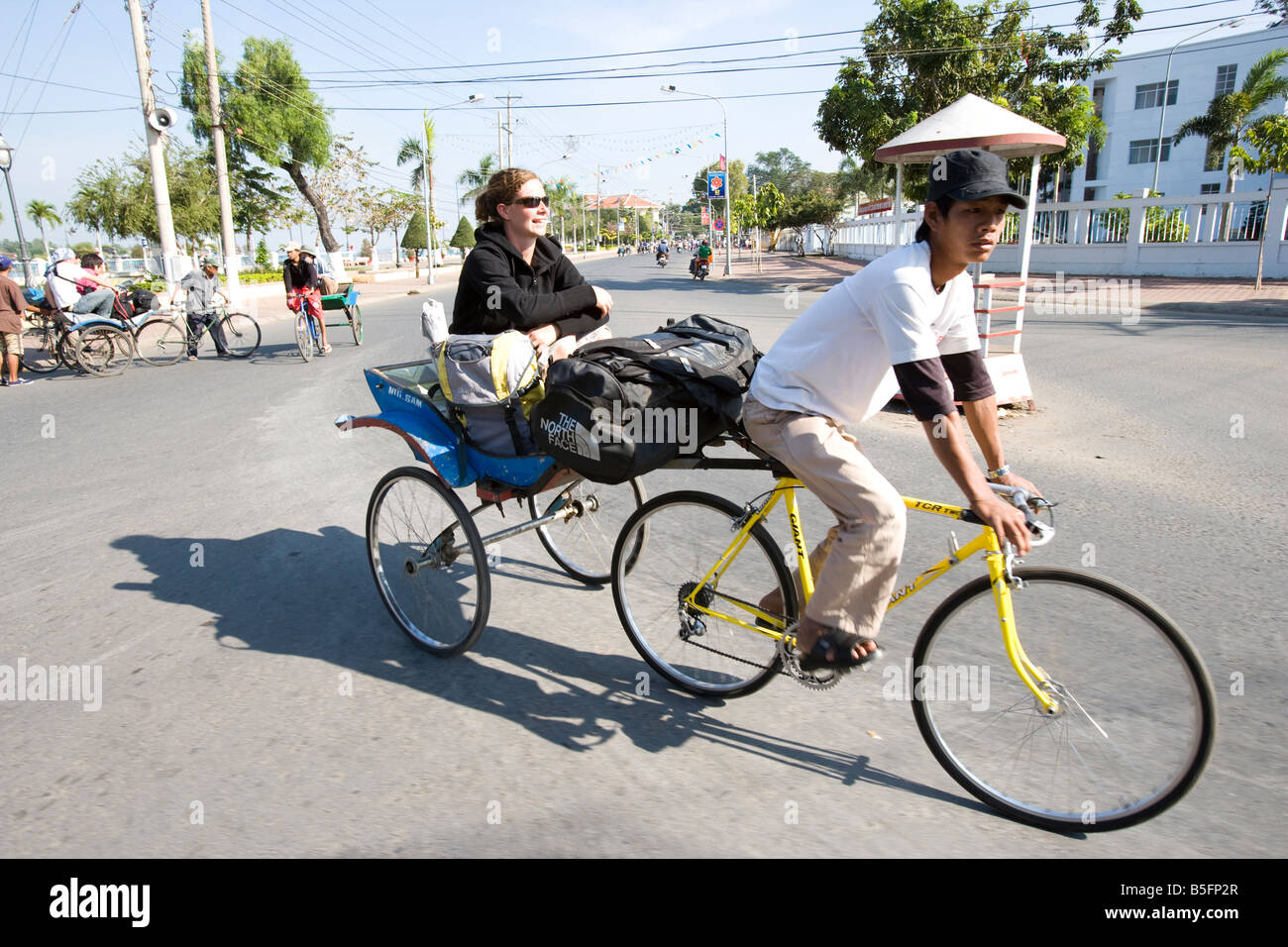 Young woman taking cyclo in the town of Chau Doc in the Mekong Delta Vietnam Stock Photo