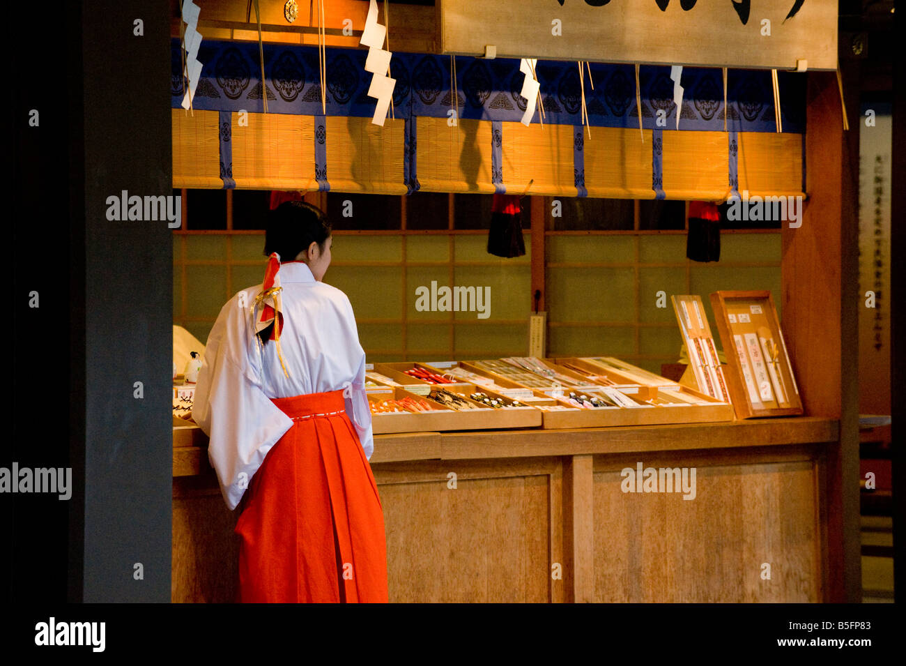 Shop assistants at a souvenir and wooden prayer card shop at the Meiji Jingu Shrine, in Tokyo, Japan. Stock Photo
