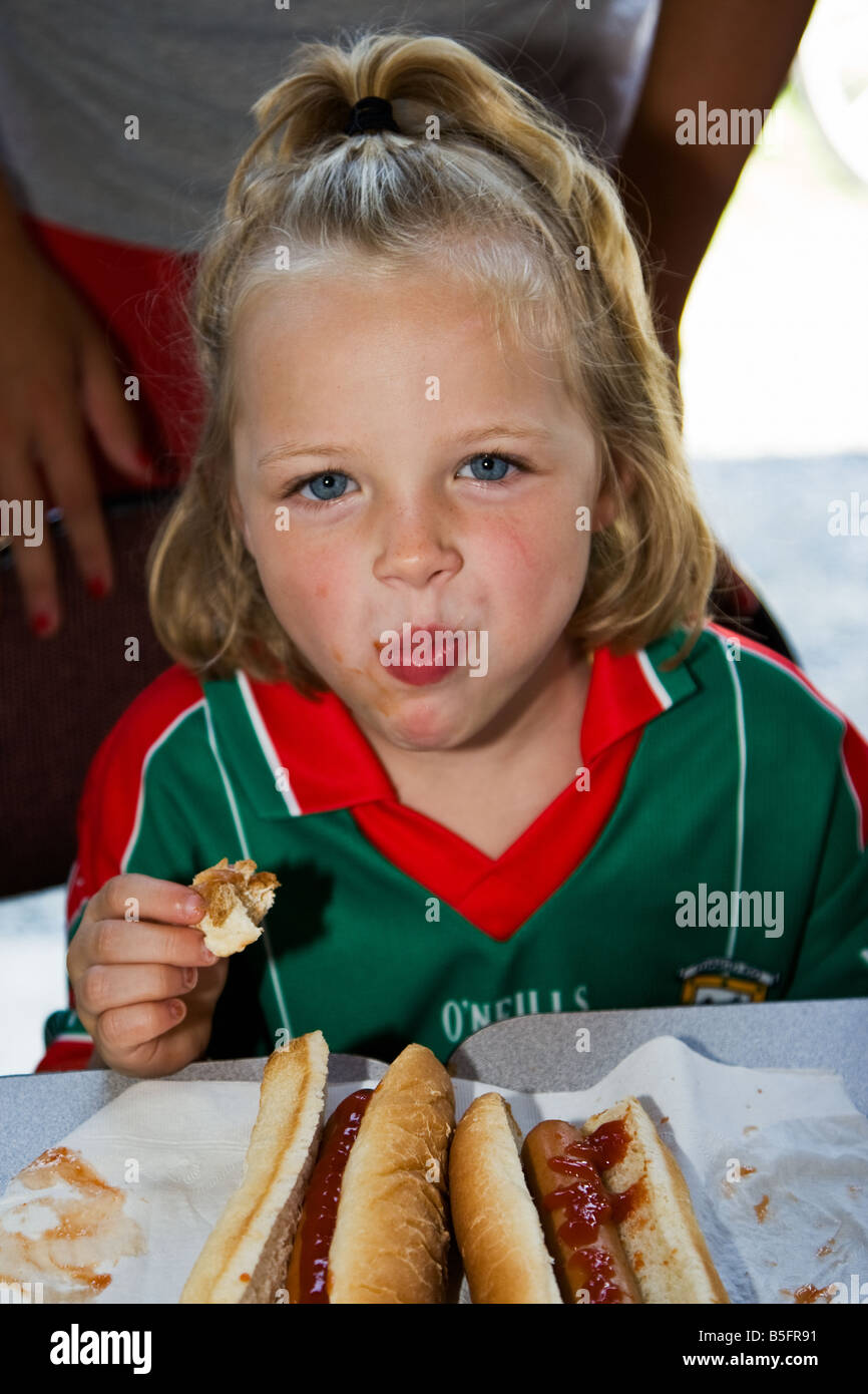 Girl eating a hot dog in a hot dog eating contest Stock Photo Alamy