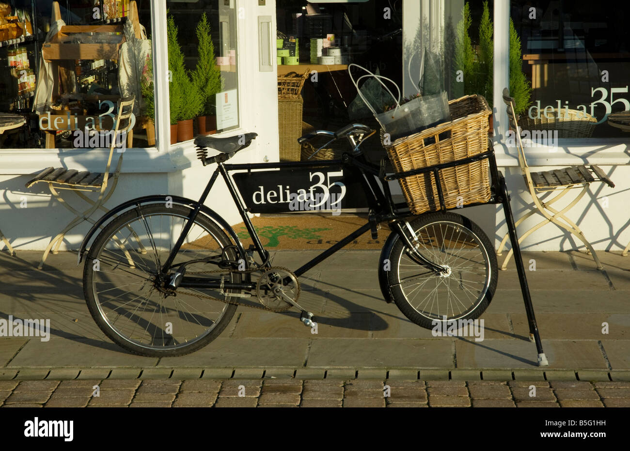 Delivery bike outside a deli shop Stock Photo