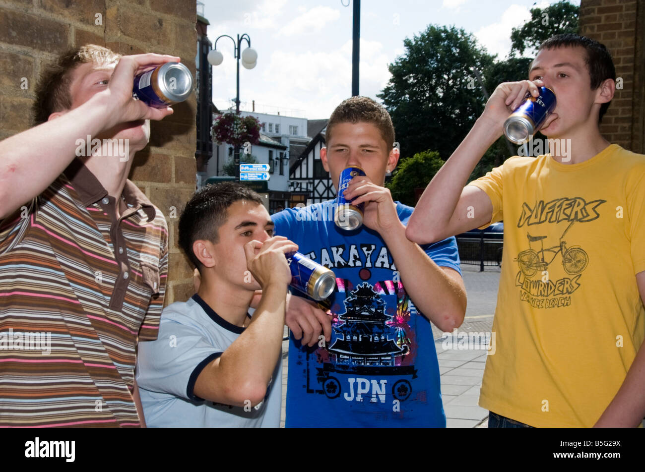 group of teenage boys drinking cans of beer Stock Photo