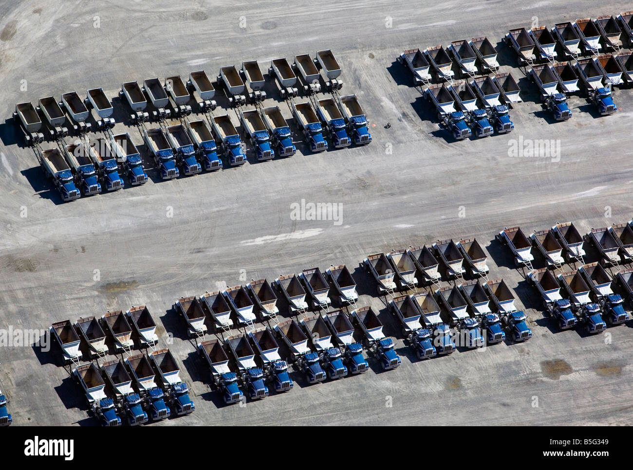 aerial view above many produce load hauling semi-trailer trucks parked in California central valley Stock Photo