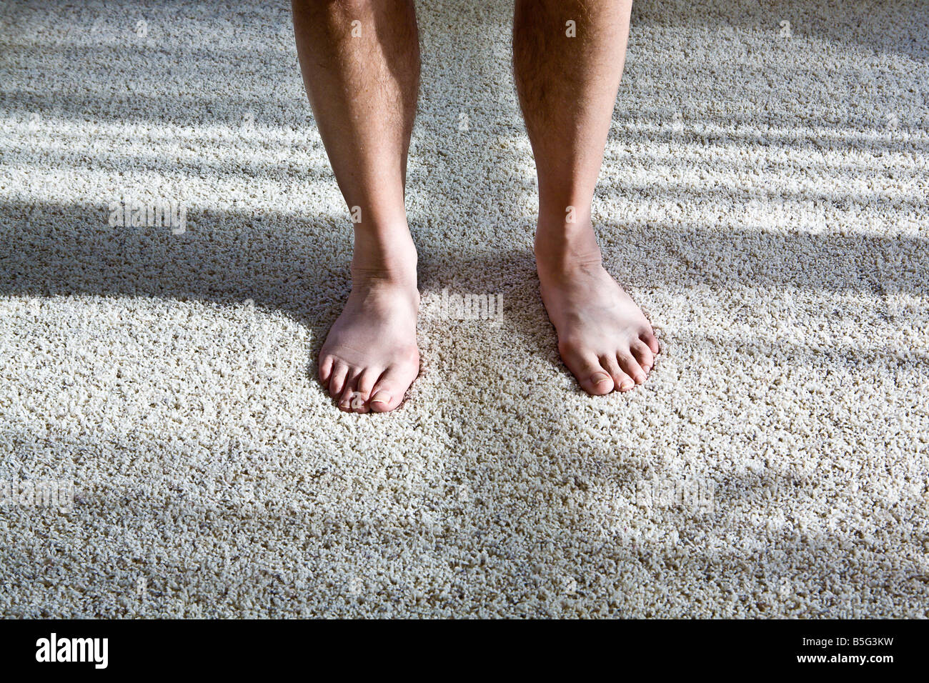 Mature adult male's bare feet on carpet Stock Photo Alamy