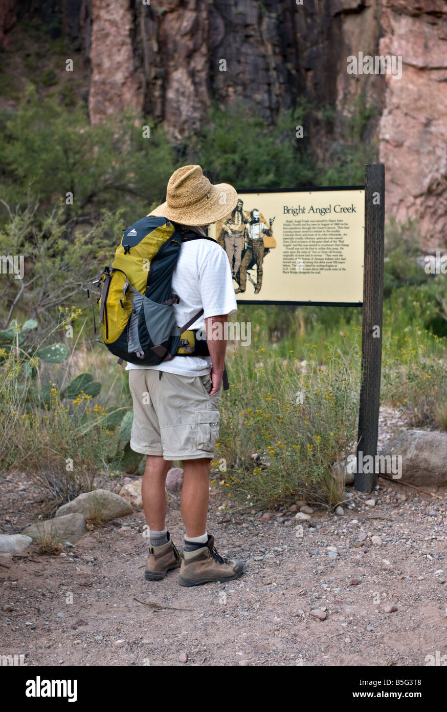 ARIZONA GRAND CANYON Hiker stops to read about Bright Angel Creek on the trail from Phantom Ranch in the Grand Canyon Stock Photo