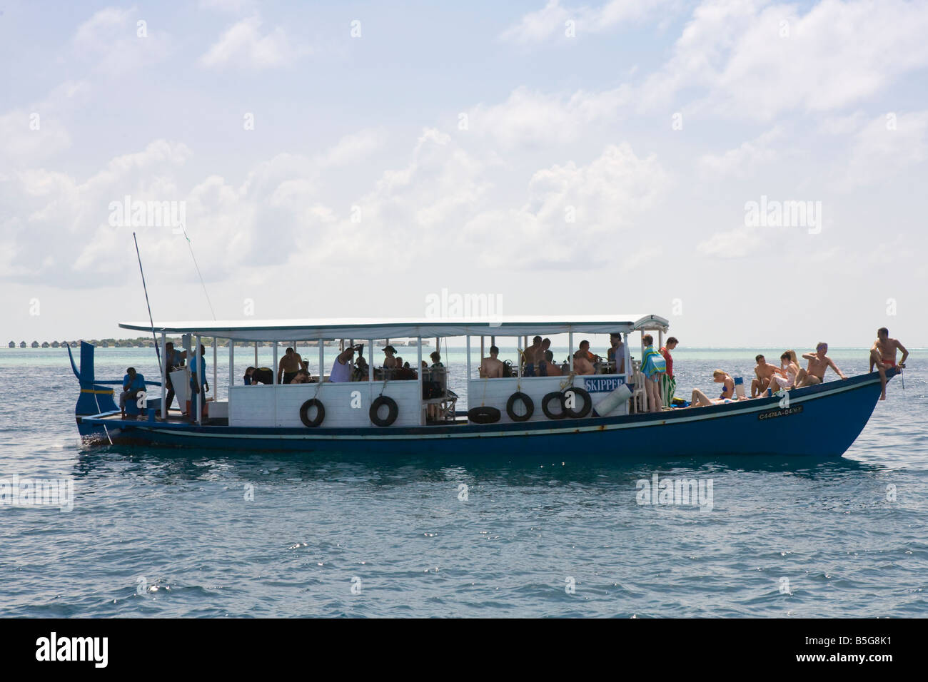 A boat full of tourists in The Maldives Stock Photo