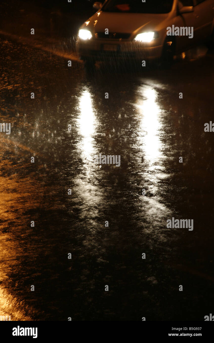 fast car driving in heavy rain at night in town Stock Photo - Alamy