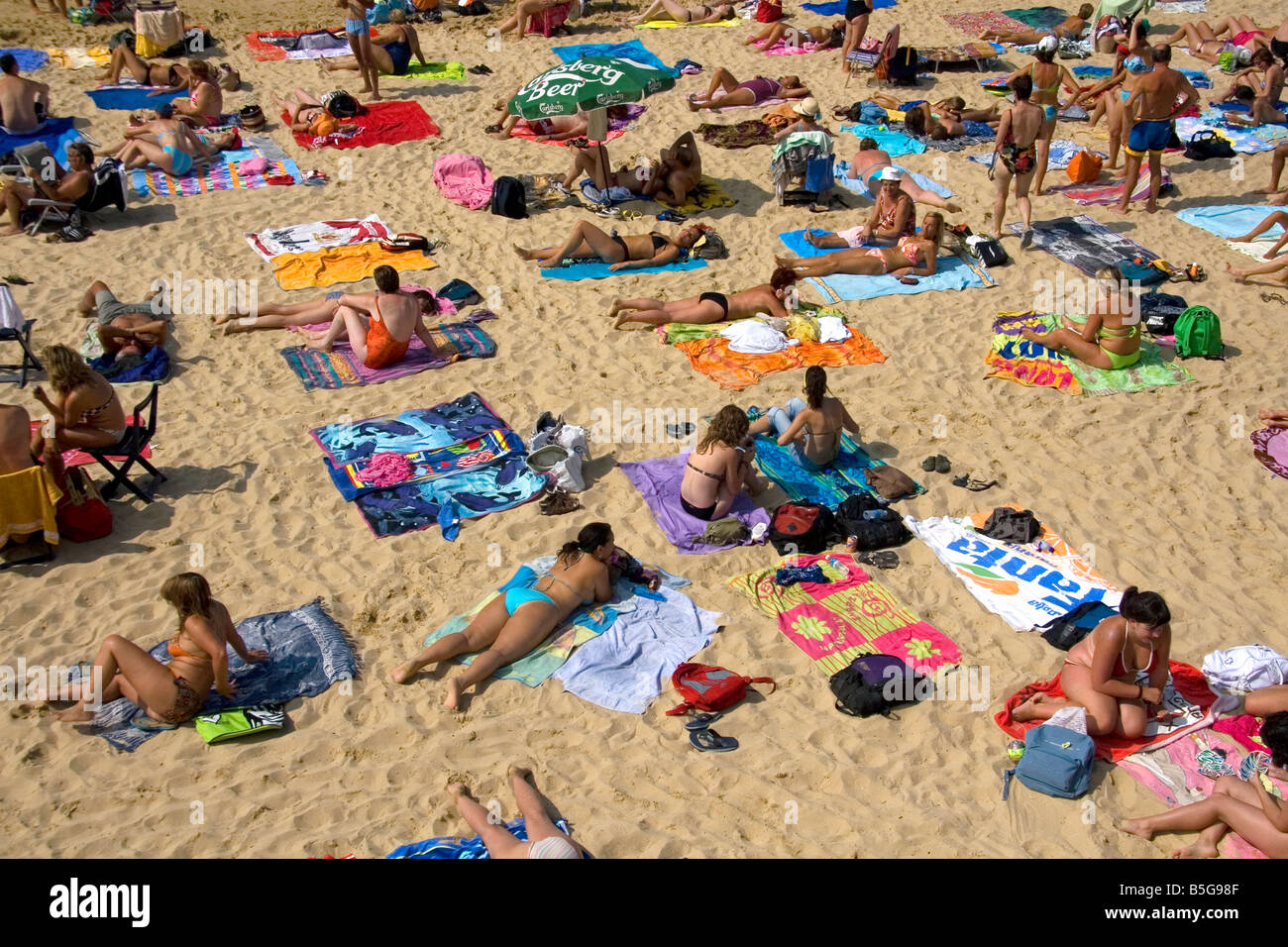 People sunbathe on the beach in the city of Donostia San Sebastian