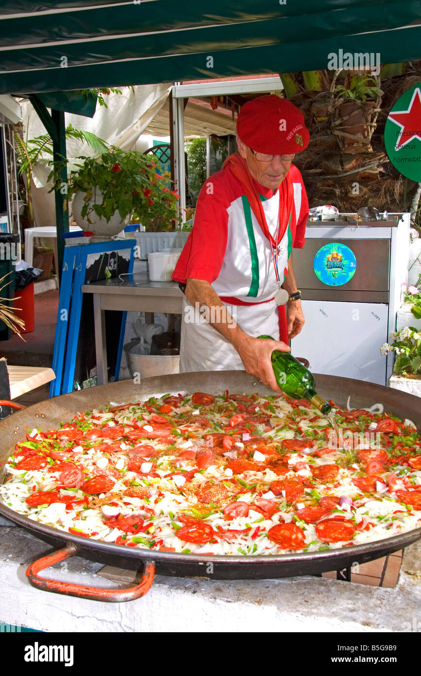 French Basque man cooking paella in the town of Biarritz Pyrenees