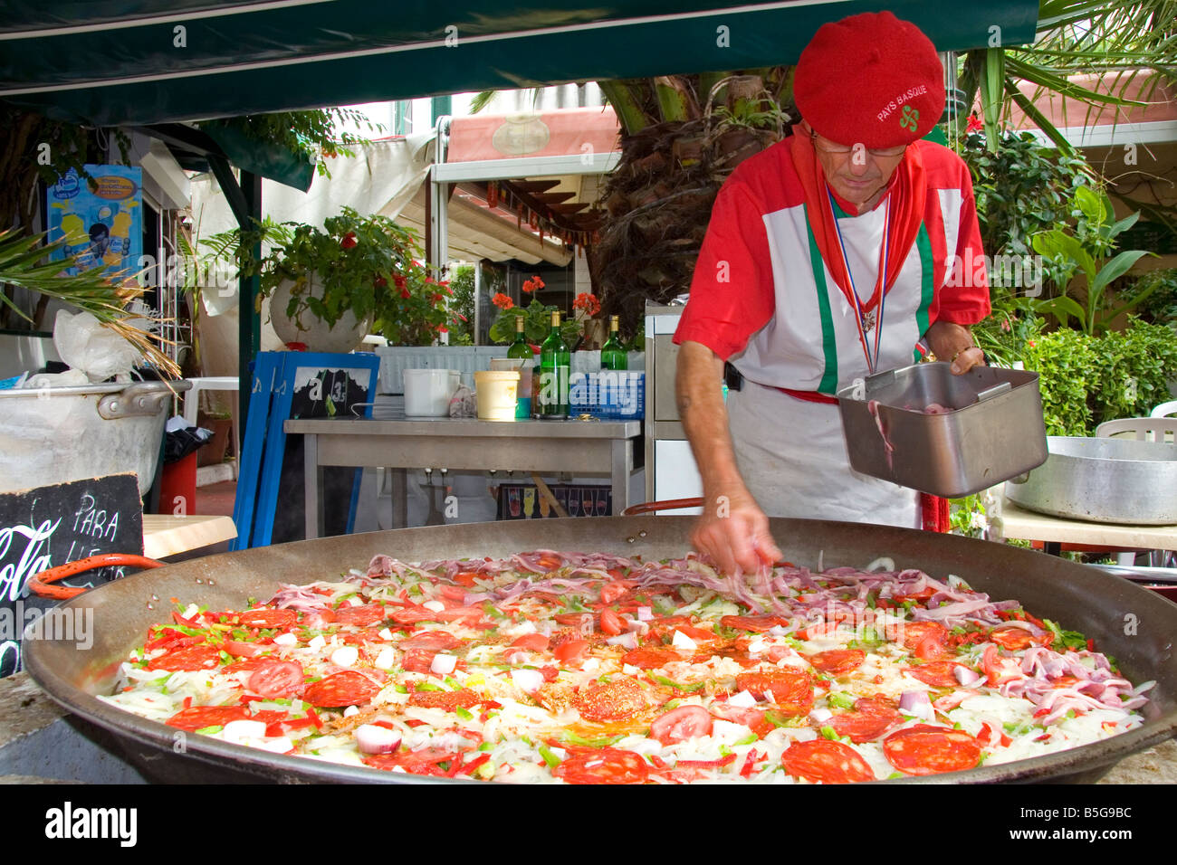 French Basque man cooking paella in the town of Biarritz Pyrenees