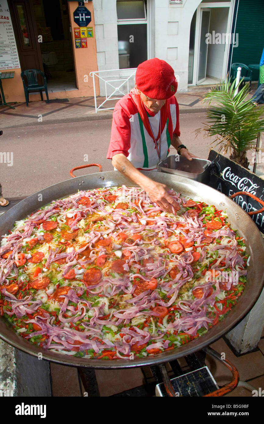 French Basque man cooking paella in the town of Biarritz Pyrenees