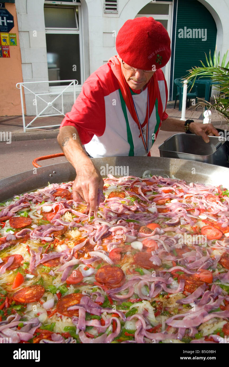 French Basque man cooking paella in the town of Biarritz Pyrenees