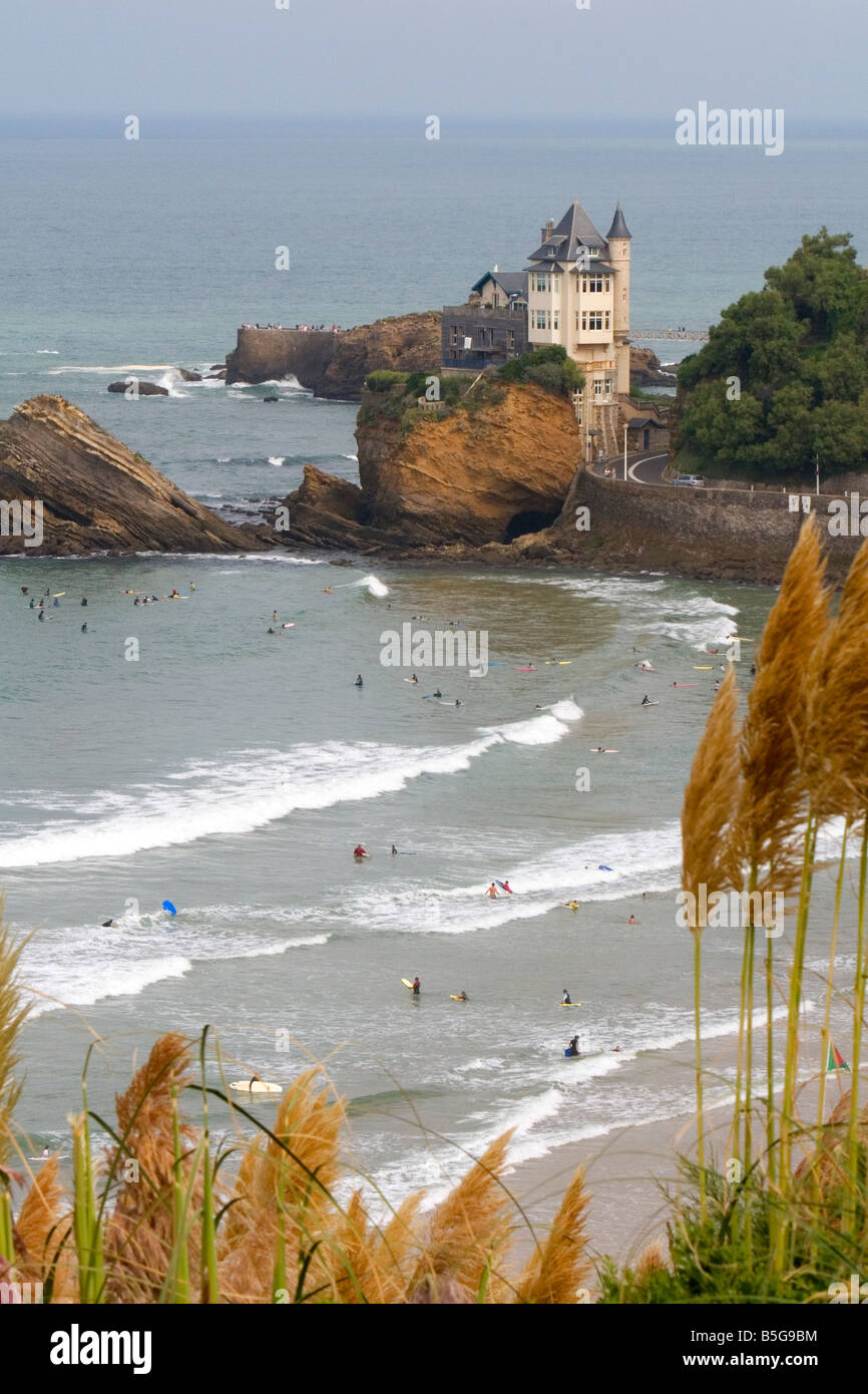 Surfing Cote de Basque below a castle in the Bay of Biscay at the town of Biarritz southwest France Stock Photo