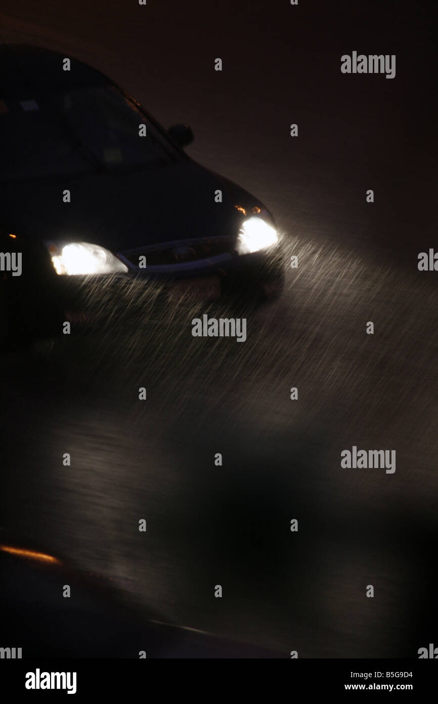 fast car driving in heavy rain at night in town Stock Photo - Alamy
