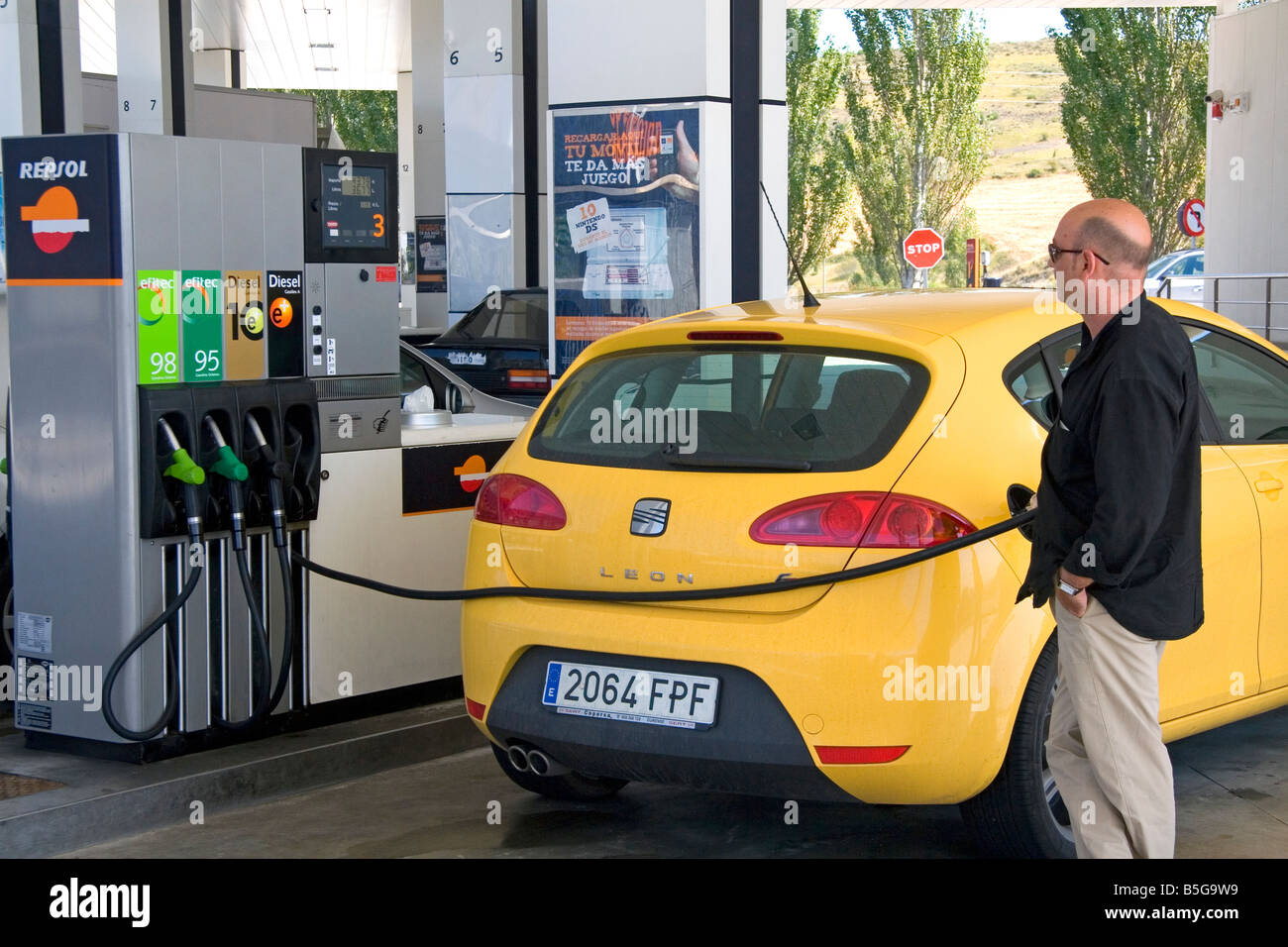 Customer putting fuel in his car at a gas station along the Autopisa