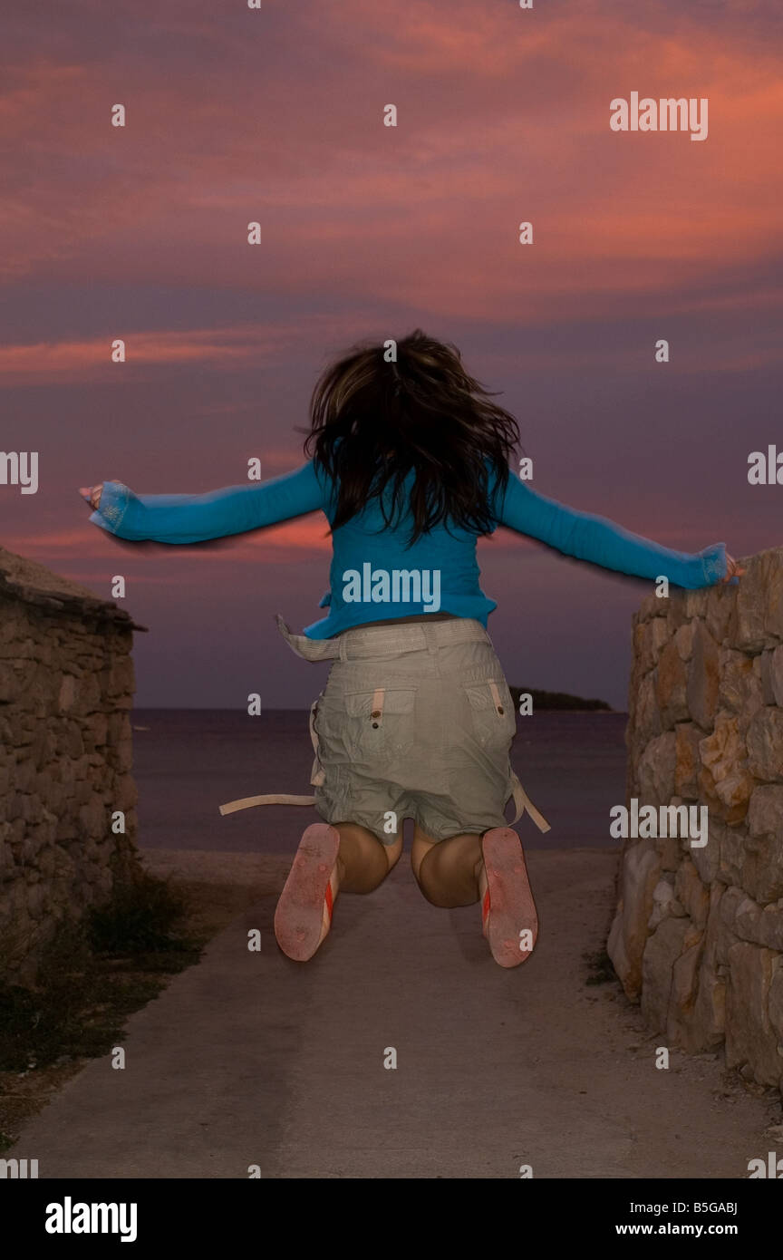 Girl jumping in the sea hi-res stock photography and images - Alamy