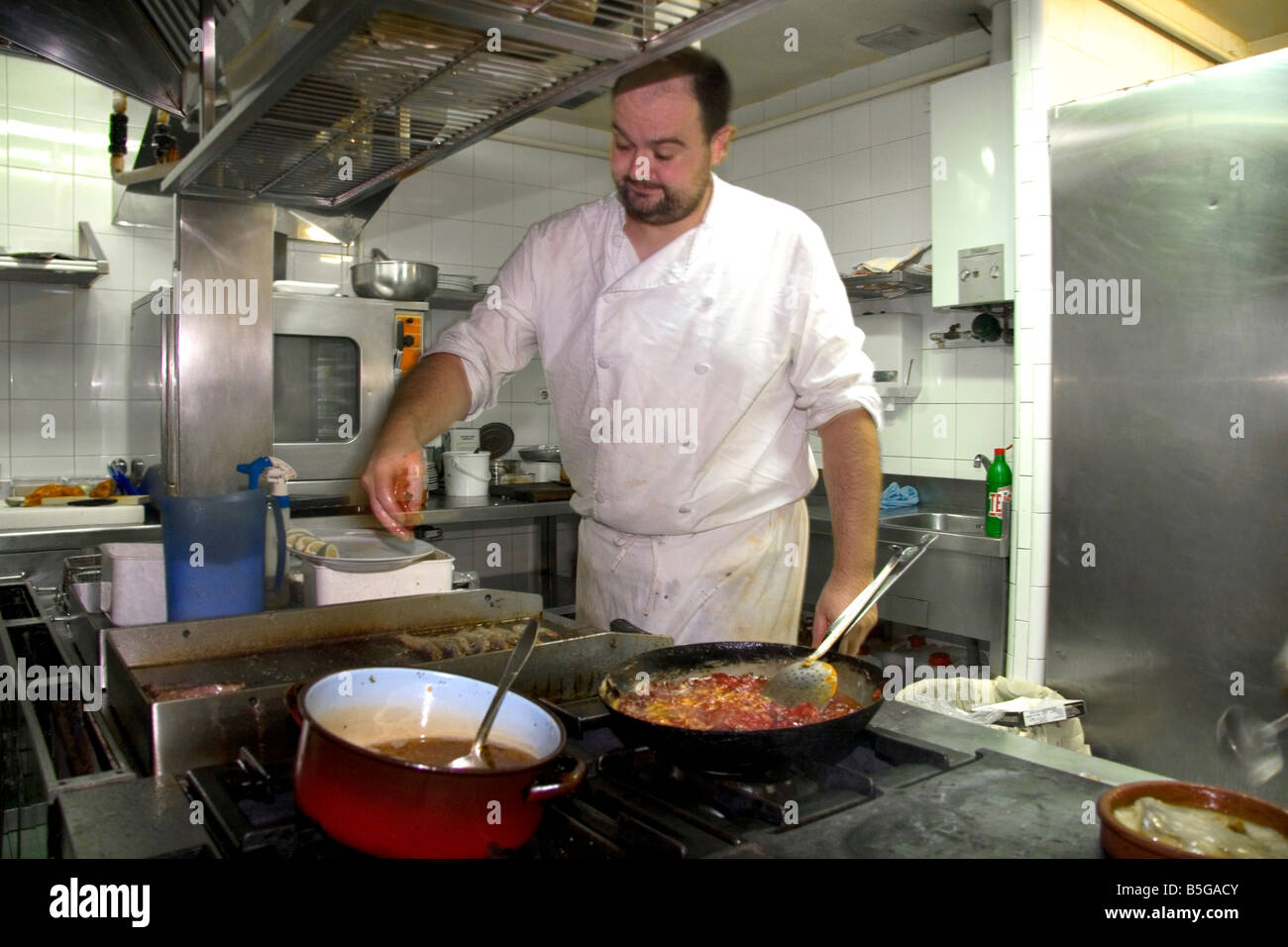 Chef cooking in the kitchen of a basque restaurant in the city of ...