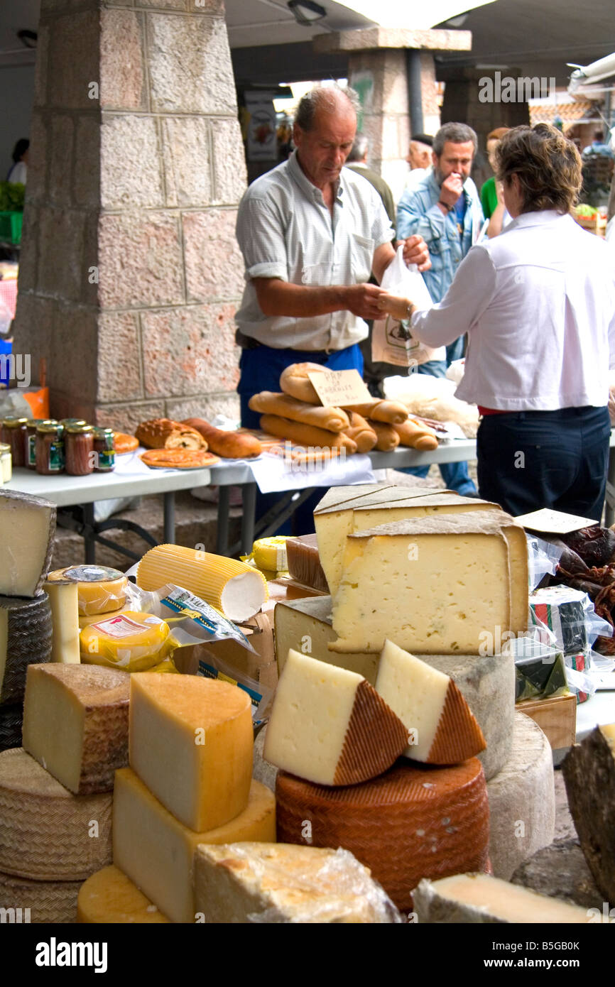 Vendors selling cheese and bread at an outdoor market in the town of Cangas de Onis Asturias northern Spain Stock Photo