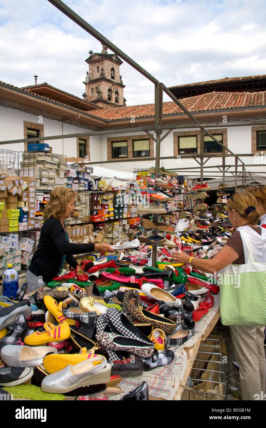 Vendor selling shoes at an outdoor market in the town of Cangas de Onis Asturias northern Spain Stock Photo