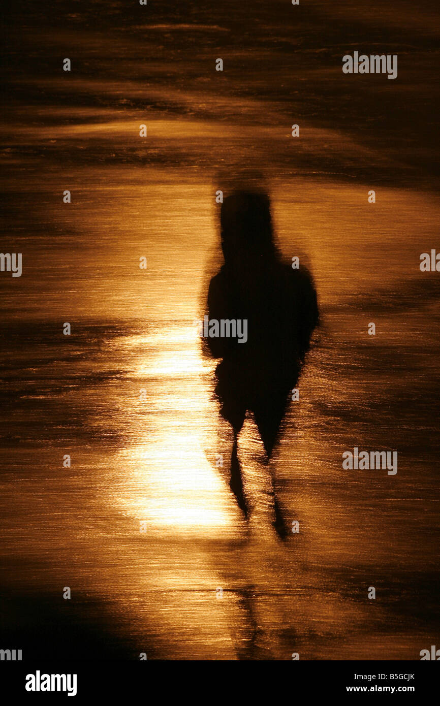 person walking in heavy rain at night in town Stock Photo