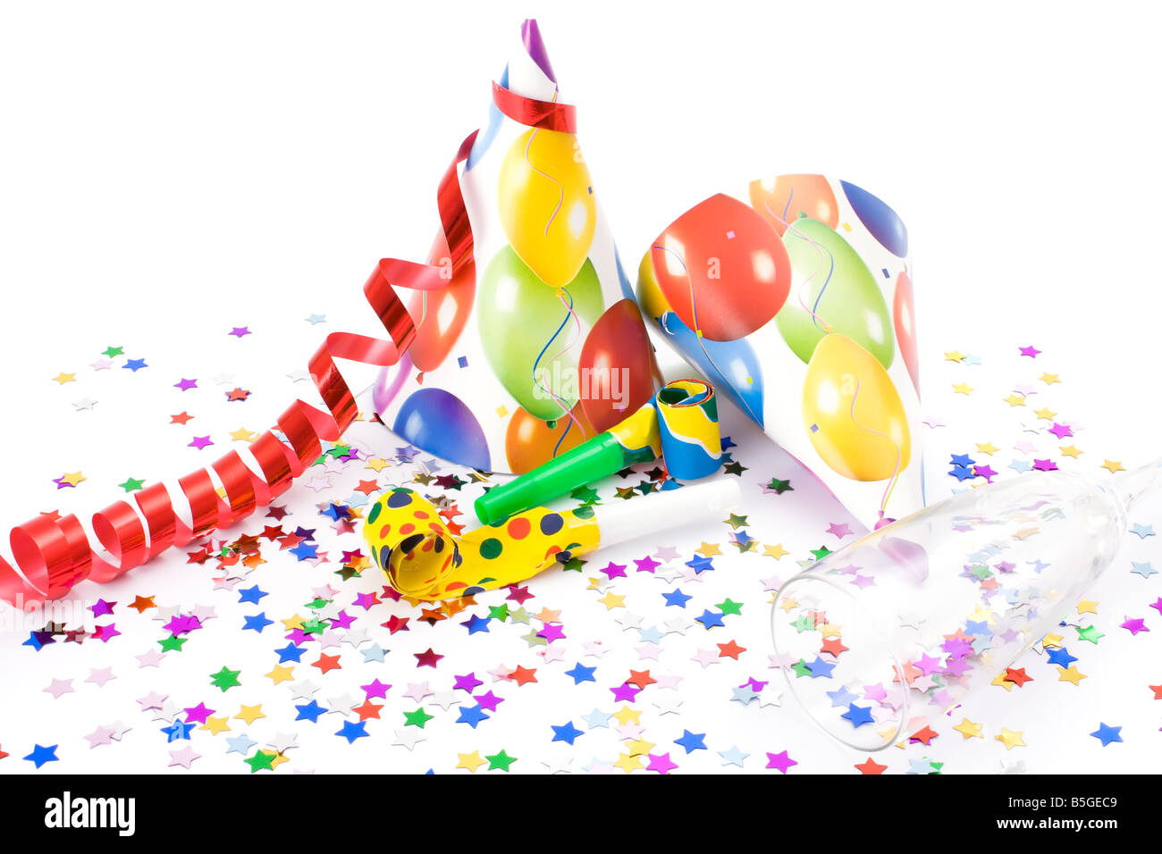 Party hats, horns or whistles and confettis on white background Stock