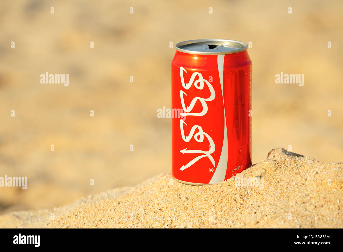 Arabic Coca Cola at the beach, Ras Al Khaimah, UAE Stock Photo