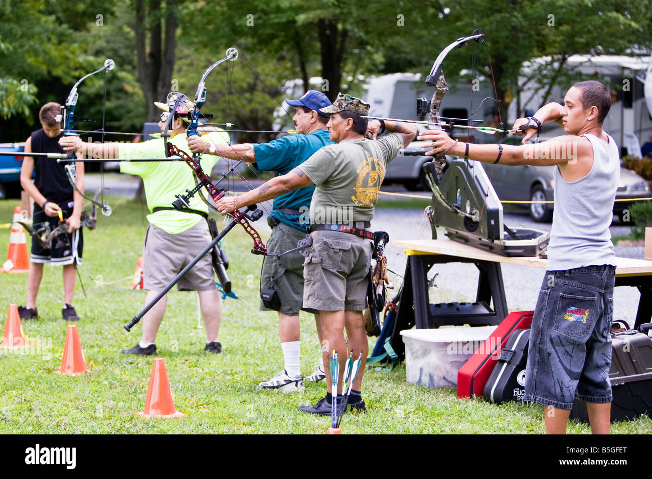 Archery professional flanked by amateurs Stock Photo Alamy