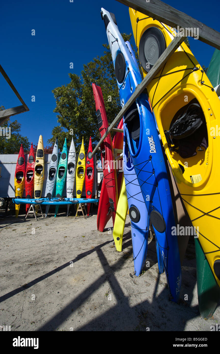 A group of multi colored Kayaks lined up for sale Stock Photo Alamy