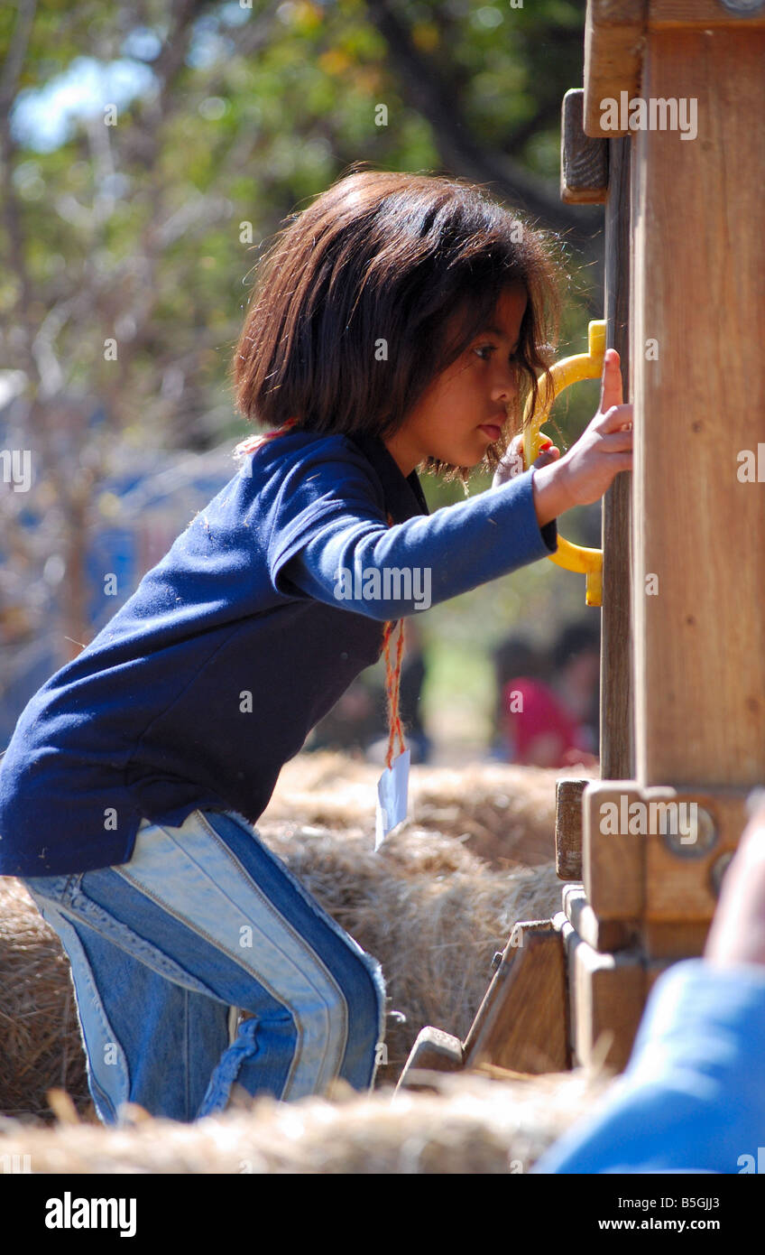 bi-racial child playing on playground Stock Photo